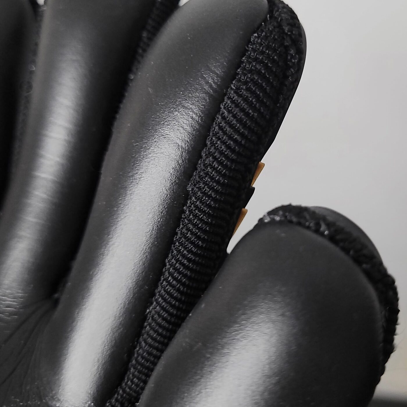 Close-up of black Contact foam latex on a goalkeeper glove palm and fingers