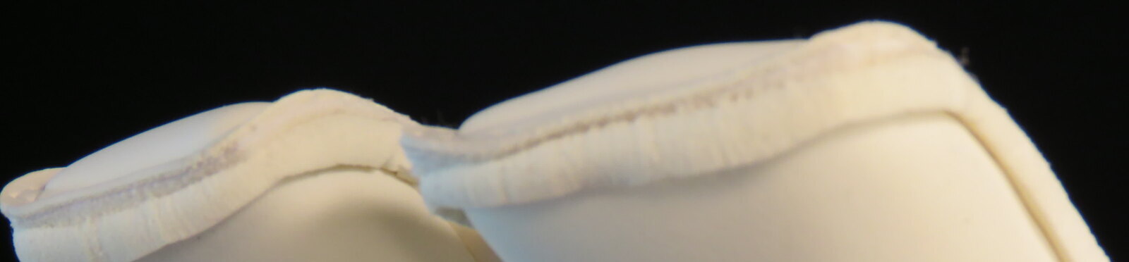 White Giga Grip foam latex on the fingertips of a goalkeeper glove